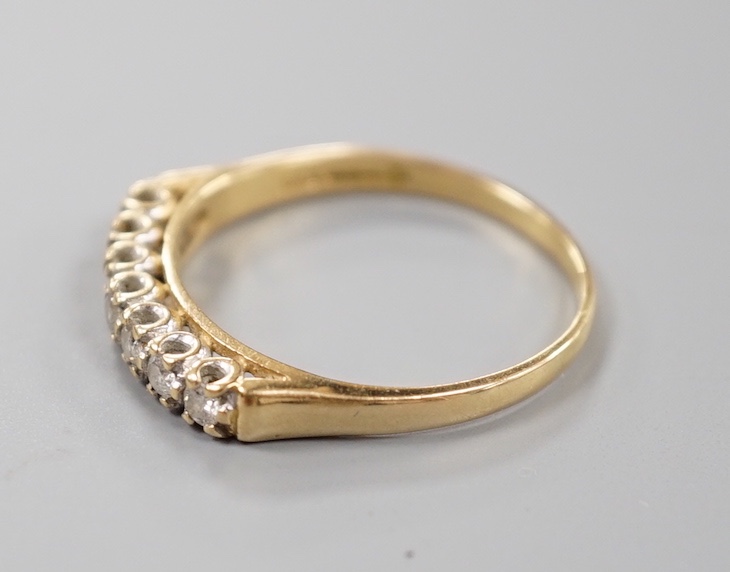 A modern 18ct gold and seven stone diamond set half hoop ring, size T/U, gross weight 3.6 grams.